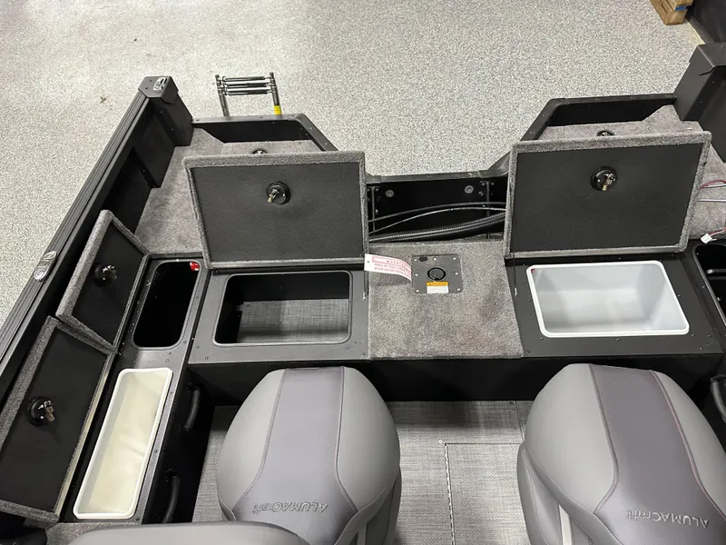 Slide: The Image of 2025 Alumacraft Competitor 175X Sport interior with storage compartments and seating. - 23