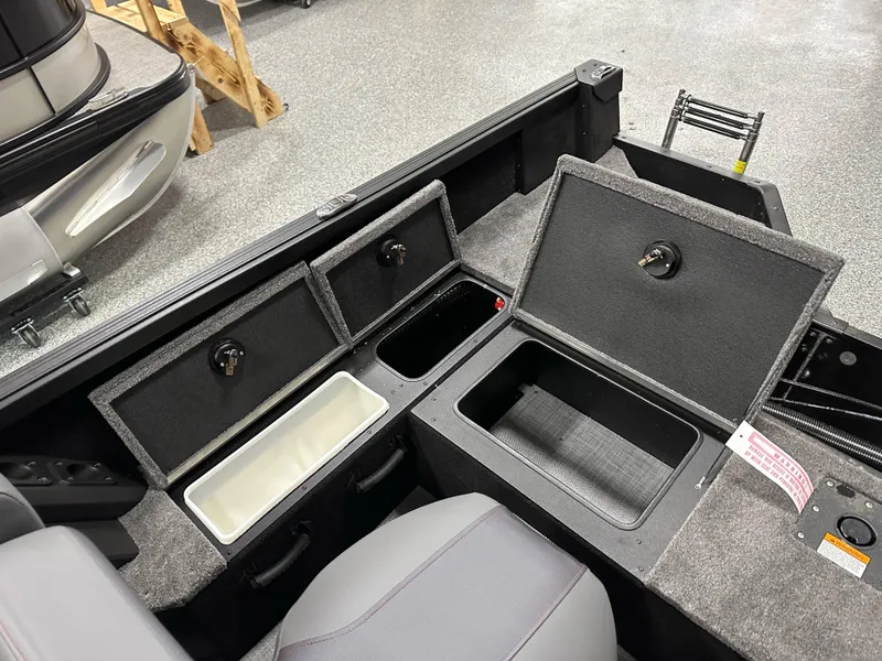 Slide: The Image of 2025 Alumacraft Competitor 175X Sport boat storage compartments and seating area. - 24