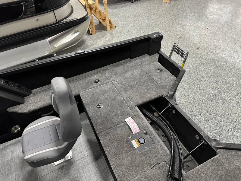 Slide: The Image of 2025 Alumacraft Competitor 175X Sport interior with gray seating and storage compartments. - 26