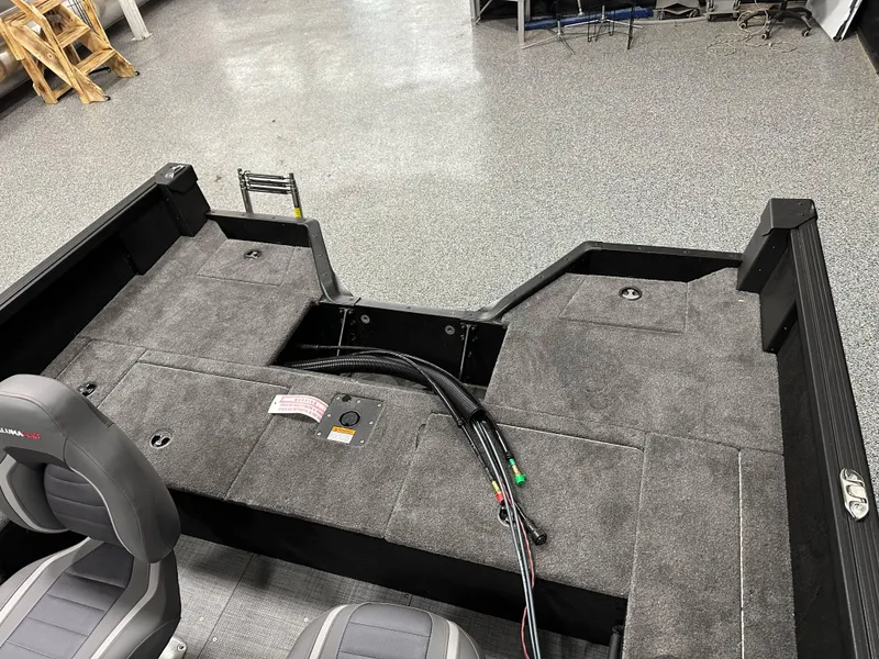 Slide: The Image of 2025 Alumacraft Competitor 175X Sport interior with gray carpet and seating. - 27