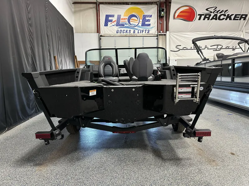 Slide: The Image of 2025 Alumacraft Competitor 175X Sport boat in showroom, rear view with seating and ladder. - 29