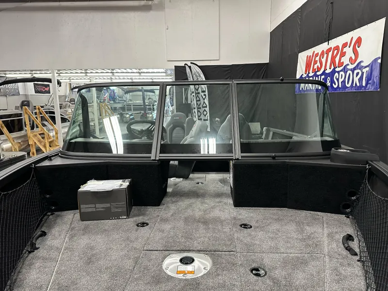 Slide: The Image of 2025 Alumacraft Competitor 175X Sport boat interior with seating and carpeted deck. - 6