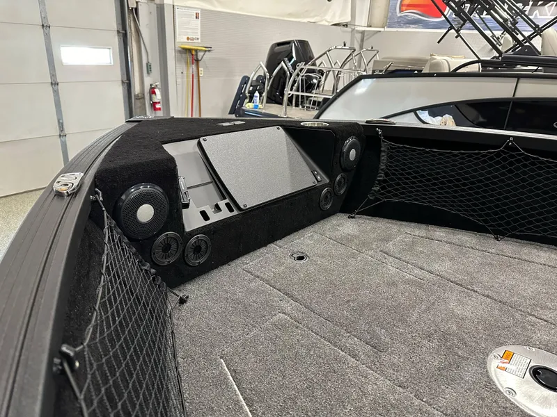 Slide: The Image of 2025 Alumacraft Competitor 175X Sport boat interior with speakers and storage nets. - 8