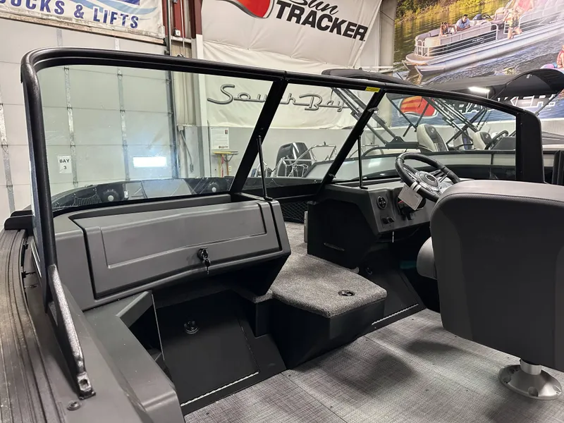 Slide: The Image of 2025 Alumacraft Competitor 175X Sport interior with steering wheel and seating in showroom. - 9