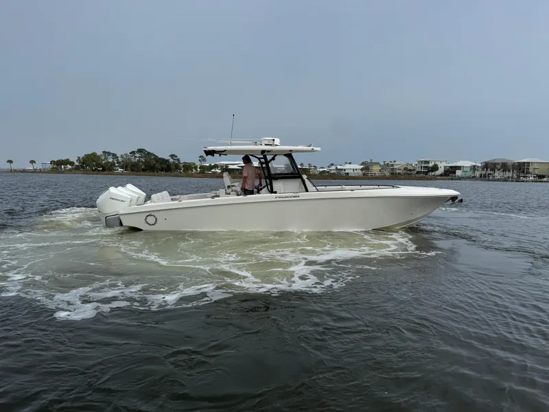 Slide: The Image of 2019 Fountain 34 CC boat cruising on a calm waterway. - 10