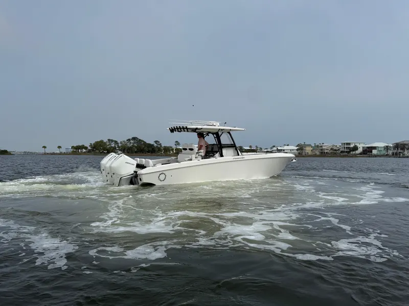 Slide: The Image of 2019 Fountain 34 CC boat cruising on a calm waterway. - 11