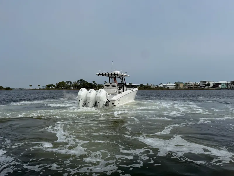 Slide: The Image of 2019 Fountain 34 CC boat cruising on open water with powerful engines. - 12