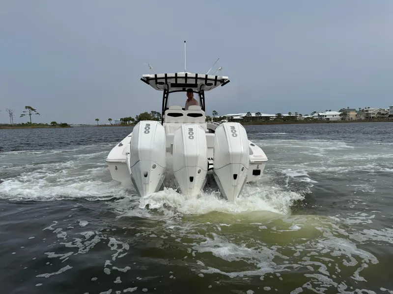 Slide: The Image of 2019 Fountain 34 CC boat with triple outboard engines on water. - 14