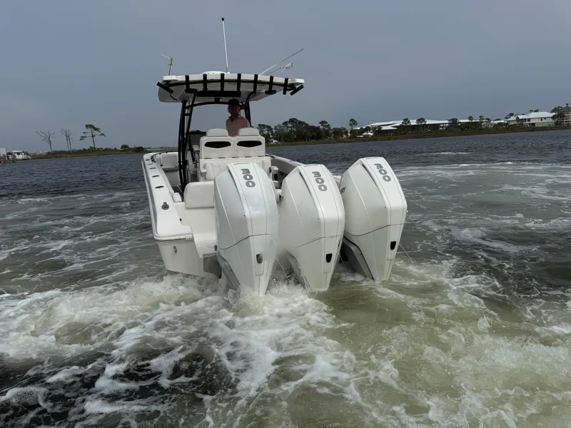 Slide: The Image of 2019 Fountain 34 CC boat with triple outboard engines on water. - 16