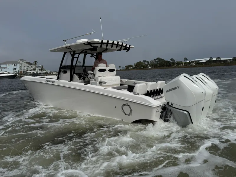Slide: The Image of 2019 Fountain 34 CC boat cruising on water with triple Mercury engines. - 18
