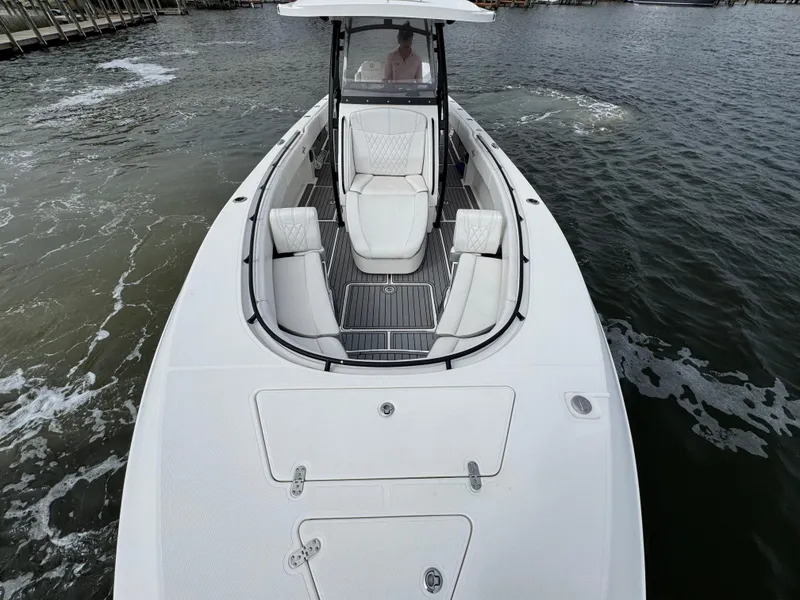 Slide: The Image of 2019 Fountain 34 CC boat on water, featuring sleek design and spacious seating. - 20