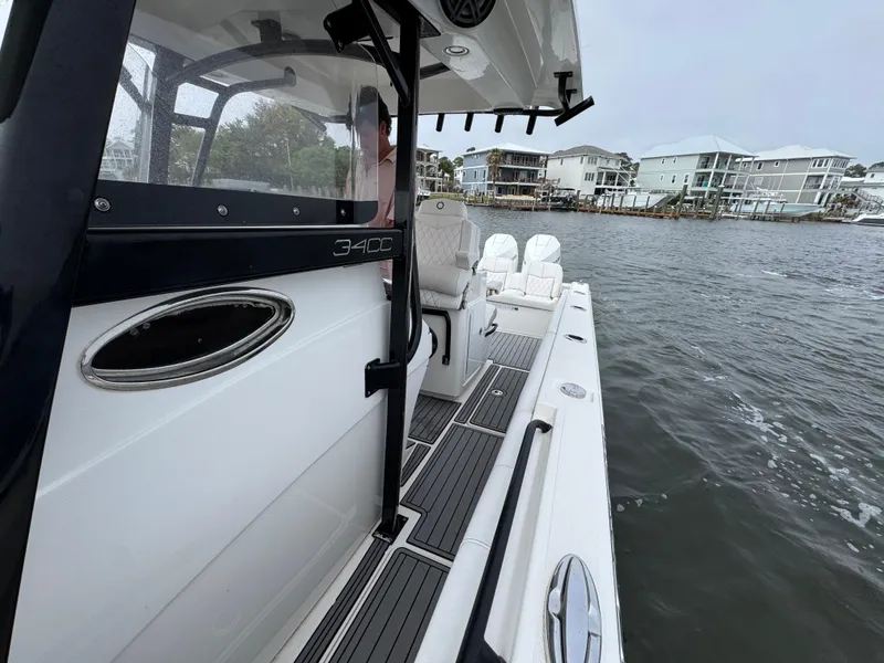 Slide: The Image of 2019 Fountain 34 CC boat on water near waterfront homes. - 24