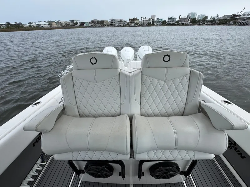 Slide: The Image of 2019 Fountain 34 CC boat with luxurious white seating on calm water. - 27
