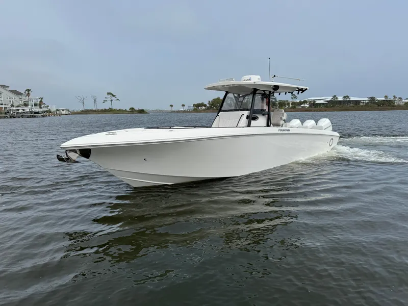 Slide: The Image of 2019 Fountain 34 CC boat cruising on calm waters. - 3
