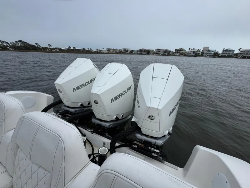 Slide: The Image of 2019 Fountain 34 CC boat with triple Mercury outboard engines on a calm waterway. - 36