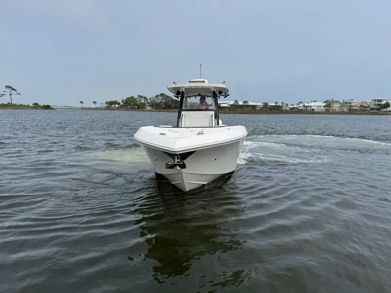 Slide: The Image of 2019 Fountain 34 CC boat cruising on calm waters near a coastal area. - 5