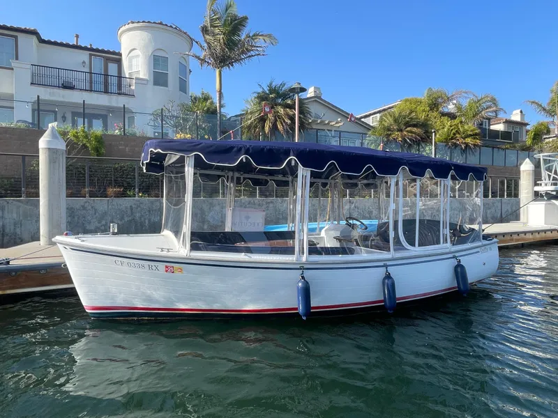 Slide: The Image of 2014 Duffy 18 Snug Harbor boat docked by waterfront homes. - 0