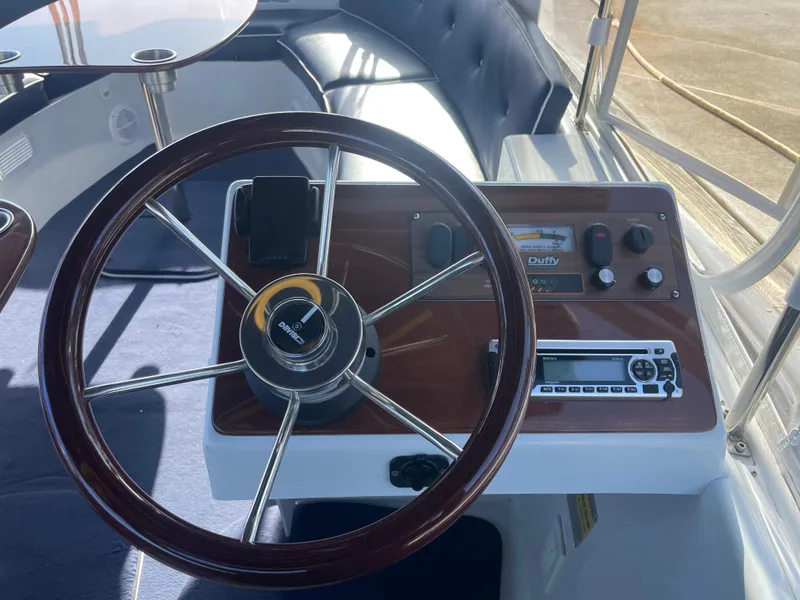 Slide: The Image of Steering wheel and dashboard of a 2014 Duffy 18 Snug Harbor boat. - 10