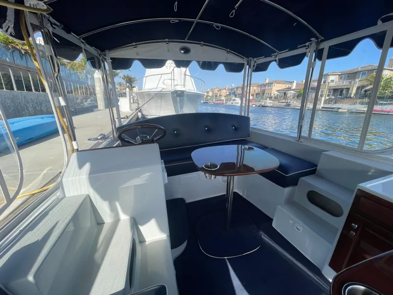 Slide: The Image of Interior of a 2014 Duffy 18 Snug Harbor boat with seating and table. - 12