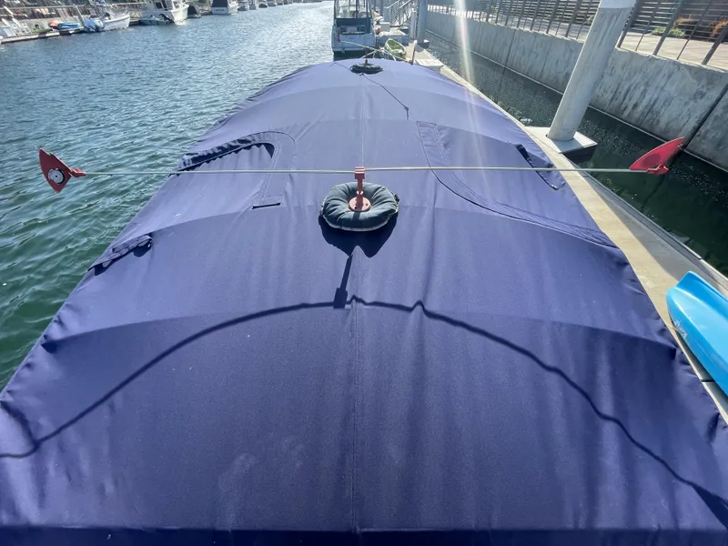 Slide: The Image of Covered 2014 Duffy 18 Snug Harbor boat docked by the water. - 20