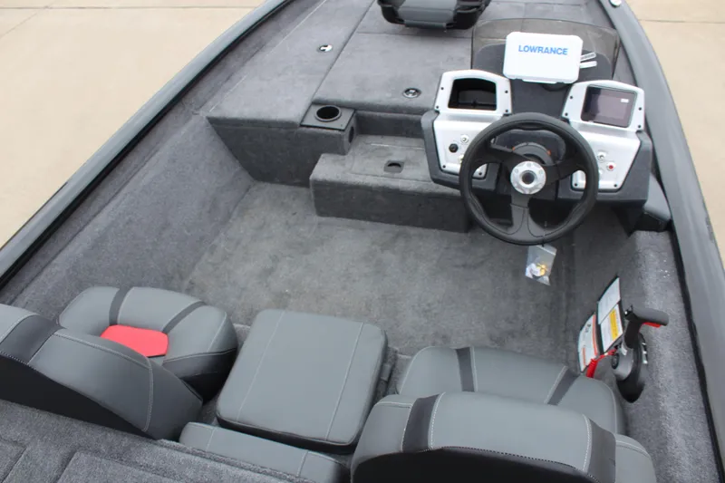 Slide: The Image of 2025 Tracker Pro Team 175 Crappie Edition boat interior with steering wheel and seating. - 11