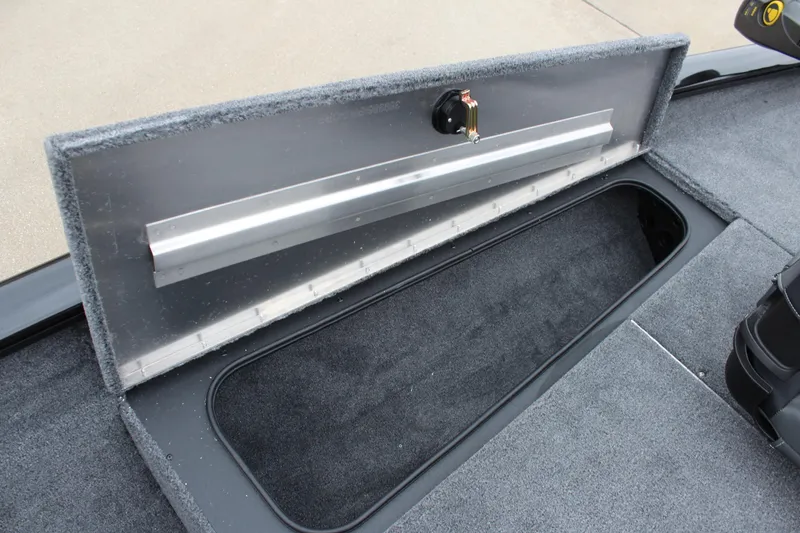 Slide: The Image of 2025 Tracker Pro Team 175 Crappie Edition boat storage compartment, open and carpeted. - 16