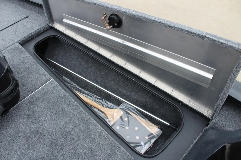 Slide: The Image of 2025 Tracker Pro Team 175 Crappie Edition boat storage compartment with fishing rod holder. - 17