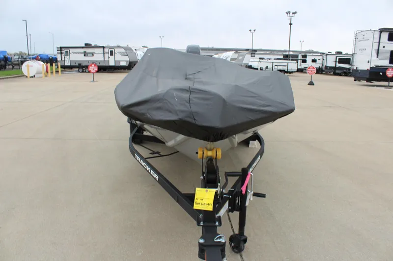 Slide: The Image of 2025 Tracker Pro Team 175 Crappie Edition boat covered, parked in a lot with RVs. - 8