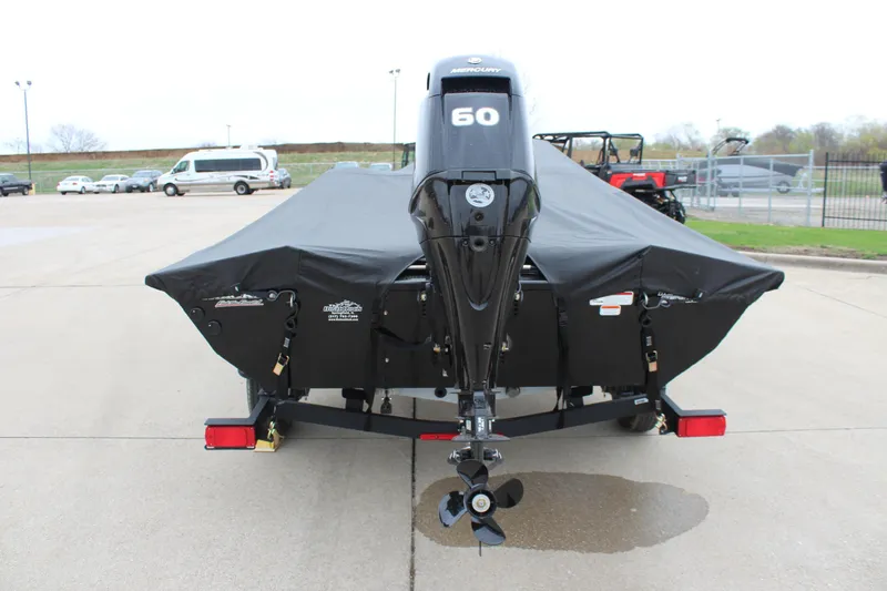 Slide: The Image of 2025 Tracker Pro Team 175 Crappie Edition boat with covered motor, parked on trailer. - 9
