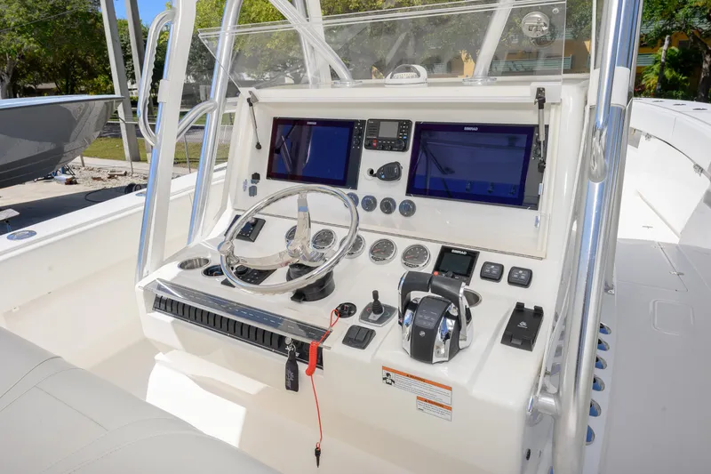 Slide: The Image of 2022 SeaVee 390Z boat console with dual screens and steering wheel. - 10