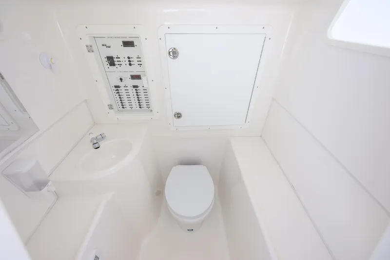 Slide: The Image of 2022 SeaVee 390Z boat interior with toilet, sink, and control panel. - 12