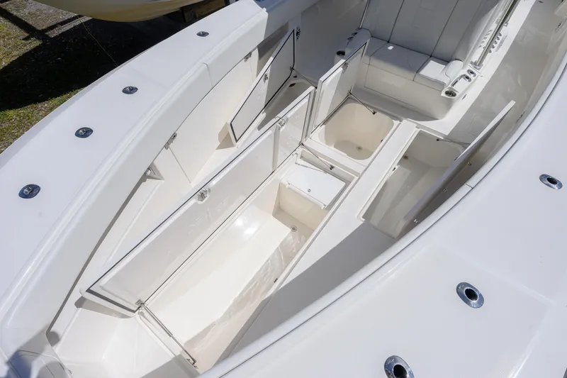 Slide: The Image of 2022 SeaVee 390Z boat interior with open storage compartments and seating area. - 13
