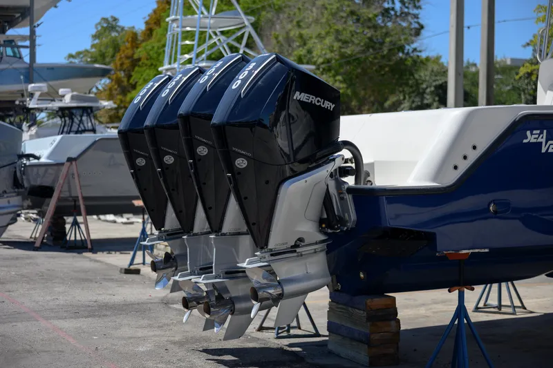 Slide: The Image of 2022 SeaVee 390Z boat with triple Mercury outboard engines in a marina setting. - 3