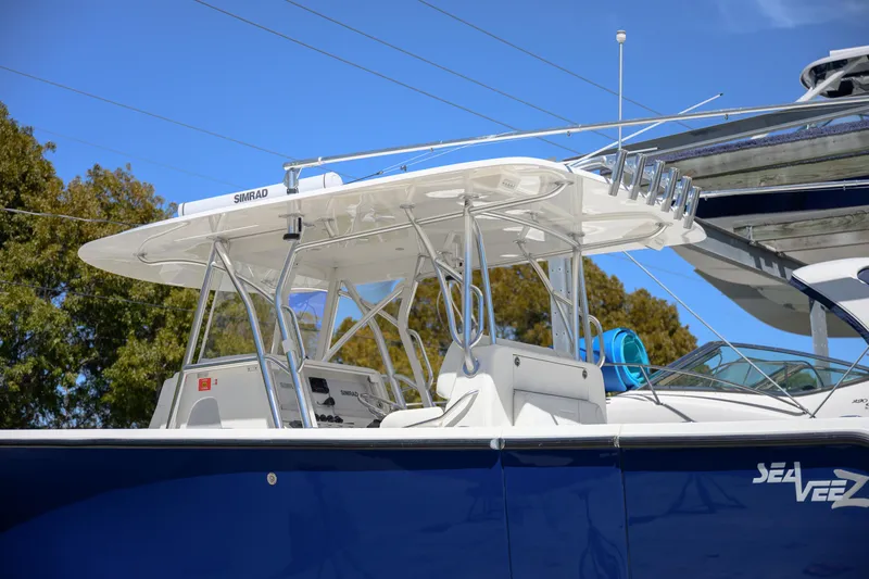 Slide: The Image of 2022 SeaVee 390Z boat with T-top, blue hull, and modern design. - 4