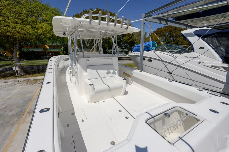 Slide: The Image of 2022 SeaVee 390Z boat with spacious deck and seating, docked under clear blue sky. - 5