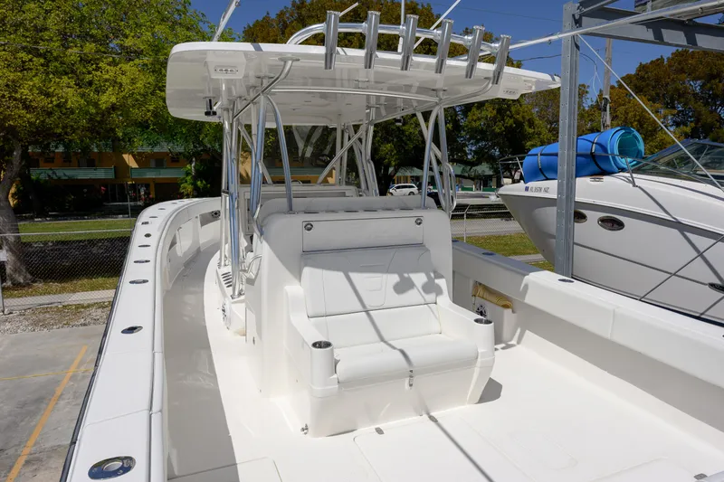 Slide: The Image of 2022 SeaVee 390Z boat with spacious deck and seating under a sturdy canopy. - 6