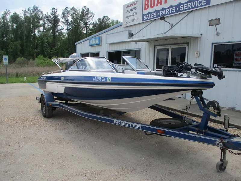 Slide: The Image of 2005 Skeeter SL 190 boat on trailer outside sales and service shop. - 1