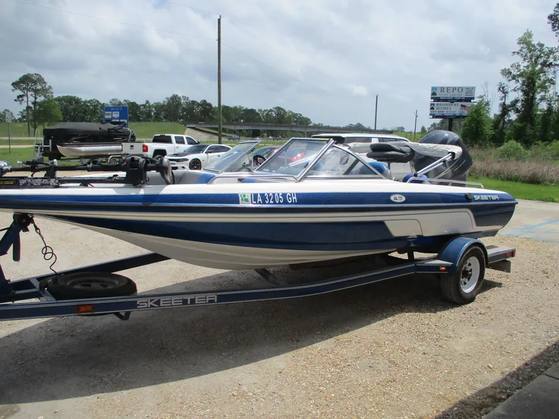 Slide: The Image of 2005 Skeeter SL 190 boat on trailer, parked outdoors, side view. - 3