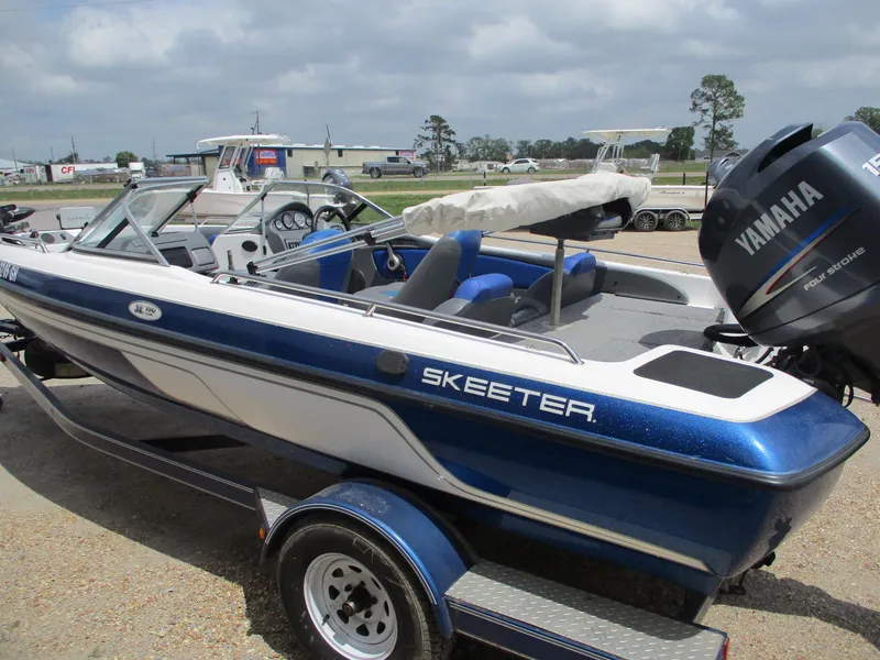 Slide: The Image of 2005 Skeeter SL 190 boat with Yamaha outboard motor, parked on a trailer. - 4