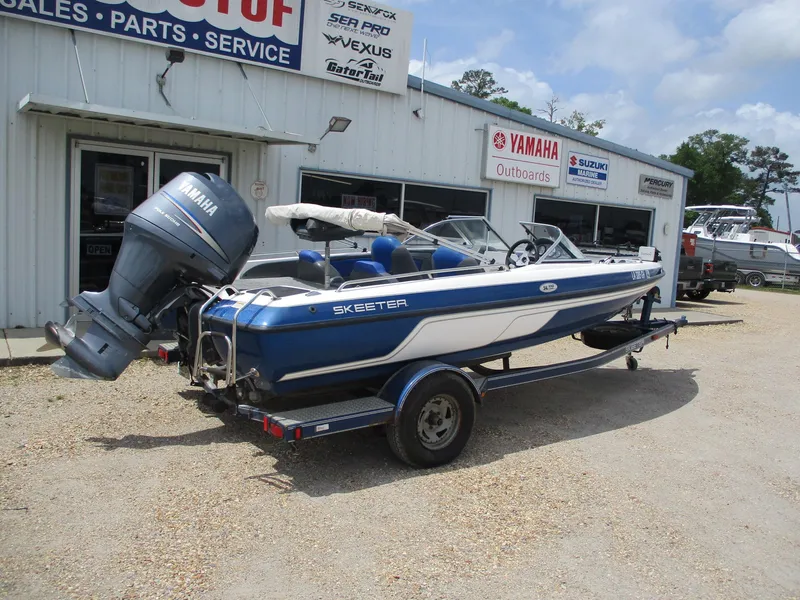 Slide: The Image of 2005 Skeeter SL 190 boat with Yamaha outboard motor parked outside dealership. - 7