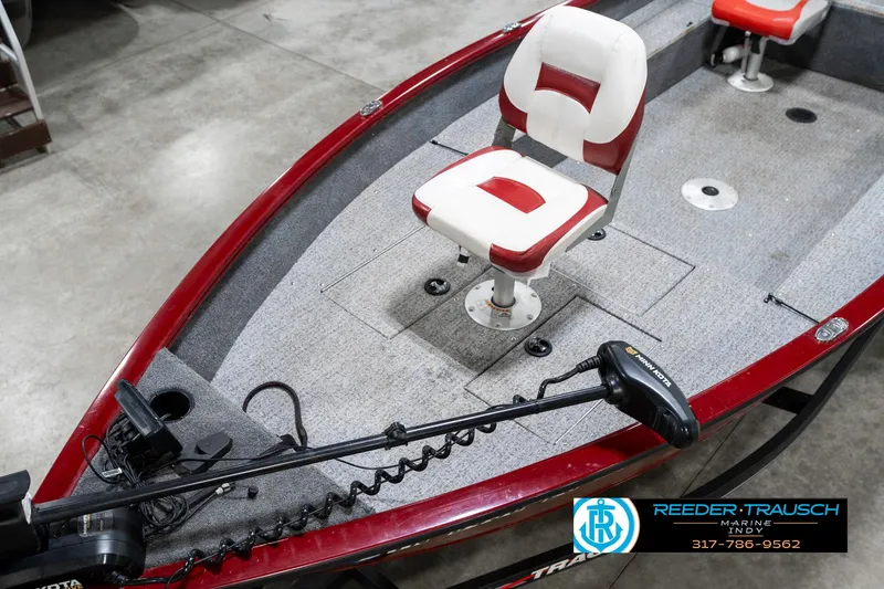 Slide: The Image of 2021 Tracker Super Guide 17 boat with red and white seating, trolling motor, and carpeted deck. - 10