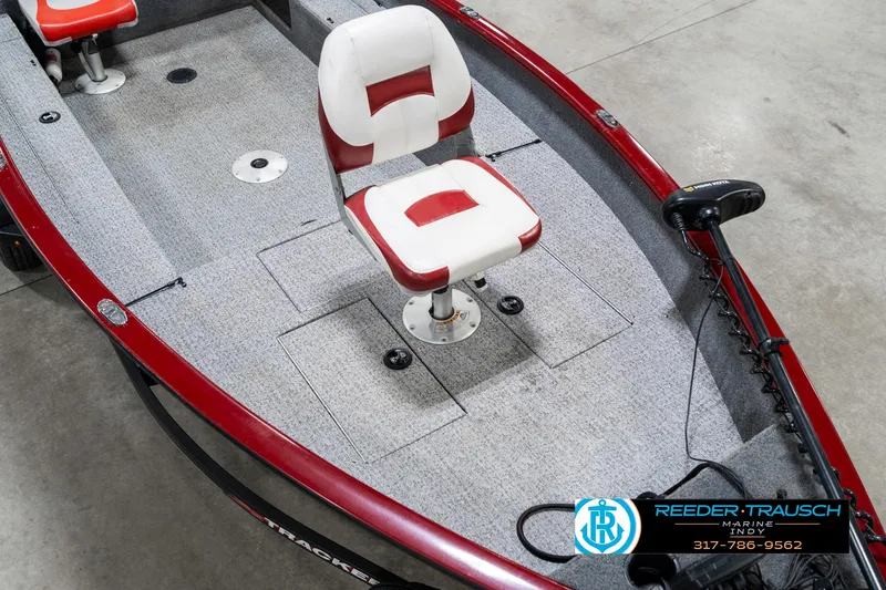 Slide: The Image of 2021 Tracker Super Guide 17 boat with red and white seating, carpeted deck. - 11