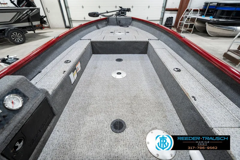 Slide: The Image of 2021 Tracker Super Guide 17 boat interior with carpeted deck and storage compartments. - 14
