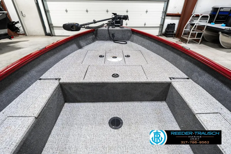 Slide: The Image of 2021 Tracker Super Guide 17 boat interior with gray carpet and storage compartments. - 15