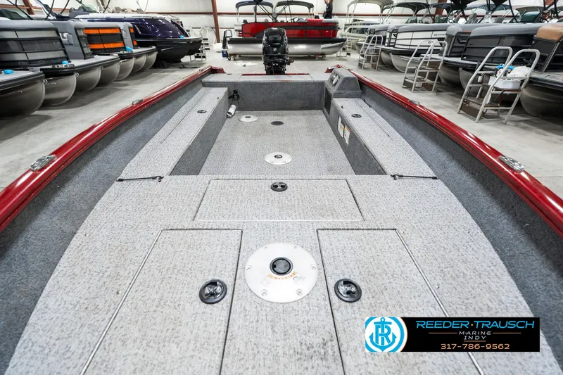 Slide: The Image of 2021 Tracker Super Guide 17 boat interior with storage compartments in a showroom. - 17