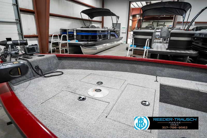 Slide: The Image of 2021 Tracker Super Guide 17 boat interior in showroom with other boats. - 21