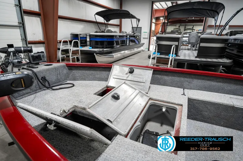 Slide: The Image of 2021 Tracker Super Guide 17 boat interior with open storage compartments in a showroom. - 22