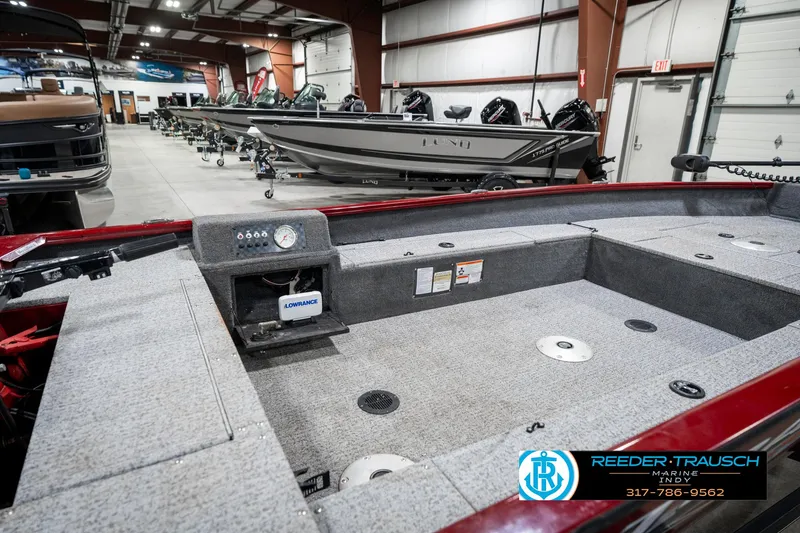 Slide: The Image of 2021 Tracker Super Guide 17 boat interior in showroom with other boats in background. - 25