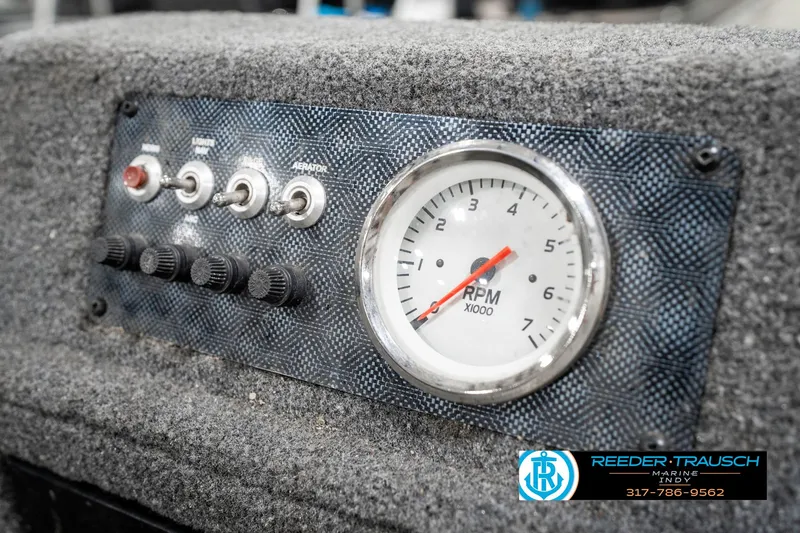 Slide: The Image of Control panel of 2021 Tracker Super Guide 17 boat with RPM gauge and switches. - 28
