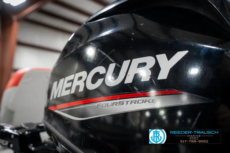 Slide: The Image of 2021 Tracker Super Guide 17 with Mercury FourStroke engine in a garage setting. - 36